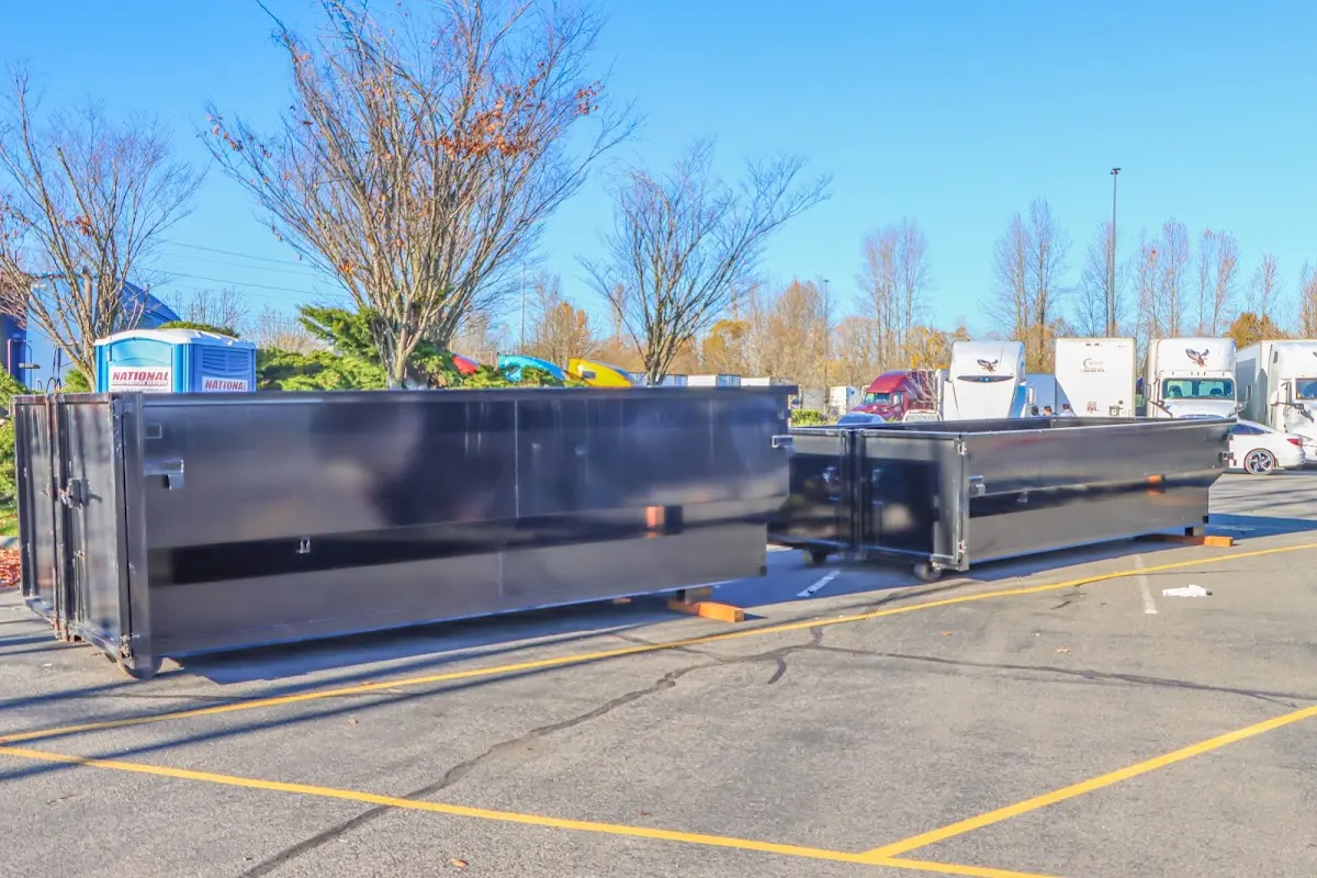 Professional dumpster rental service with roll-off container on residential driveway in Denton